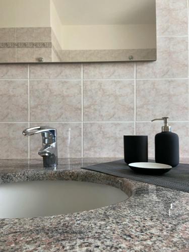 a bathroom counter with a sink and a faucet at Casa Luelda in San Maurizio Canavese
