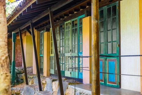 a building with colorful doors and windows on it at Sama Retreats - Kosgoda in Kosgoda
