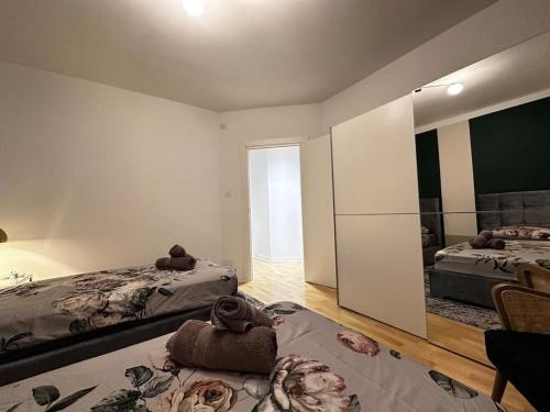 a large room with two beds and a mirror at Sunshine Apt in Central Sliema in Sliema