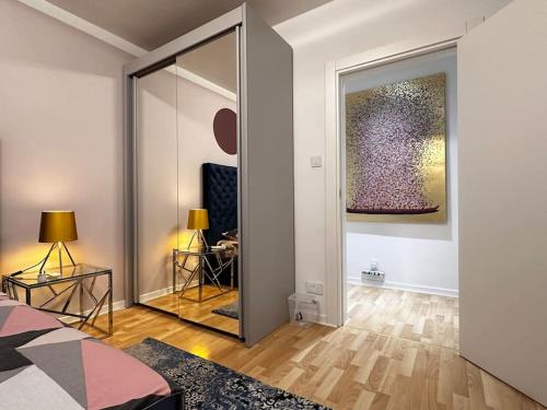 a bedroom with a mirror and a bed in a room at Sunshine Apt in Central Sliema in Sliema