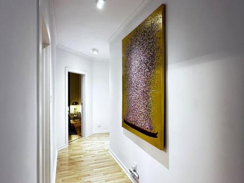 a hallway with a painting hanging on a wall at Sunshine Apt in Central Sliema in Sliema