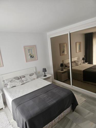 a bedroom with two beds and a large mirror at Apartament - dom, Hiszpania Andaluzja, Costa del Sol in Estepona