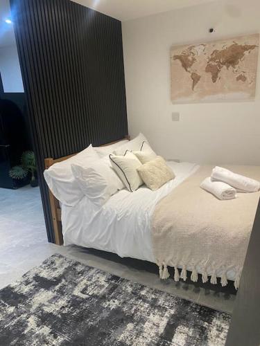 a bed with white sheets and pillows in a room at The Courtyard - By Casa Living in Canley