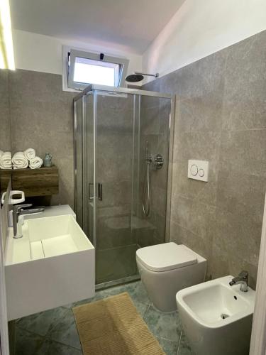 a bathroom with a shower and a toilet and a sink at -Torre dei Corsari- TERRAZZA SUL MARE in Torre Dei Corsari
