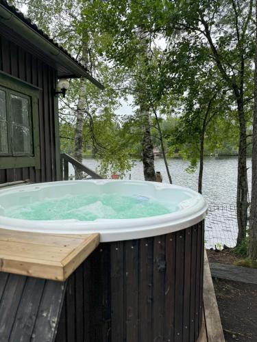 a hot tub on the deck of a house at Lakeview apartment, Espoo in Espoo