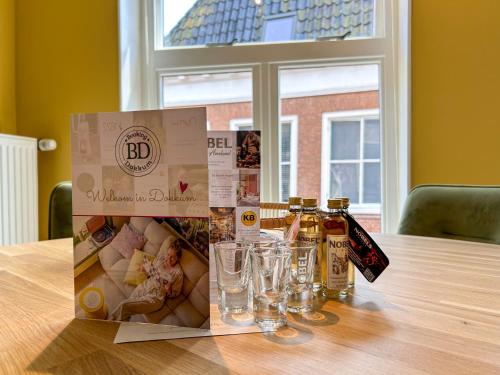 a box of beer and glasses on a table at Luxe familie appartement bij de Waegh Dokkum in Dokkum