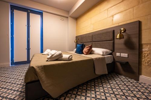 a bedroom with a bed with two pillows on it at Casa Rosanna Malta B&B Adults only 16 plus in Marsaskala