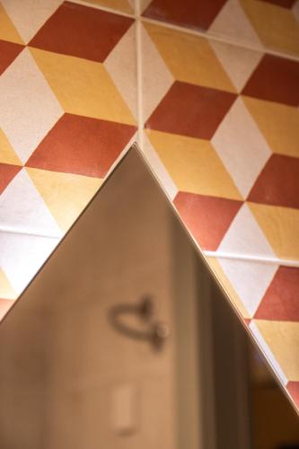 a close up of a bathroom floor with a door at Casa Rosanna Malta B&B Adults only 16 plus in Marsaskala