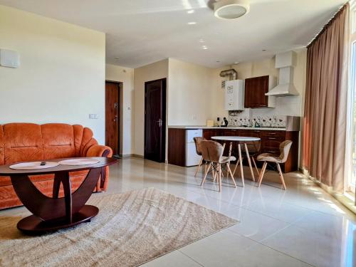 a living room with a couch and a table at Vienas po kitu in Šventoji