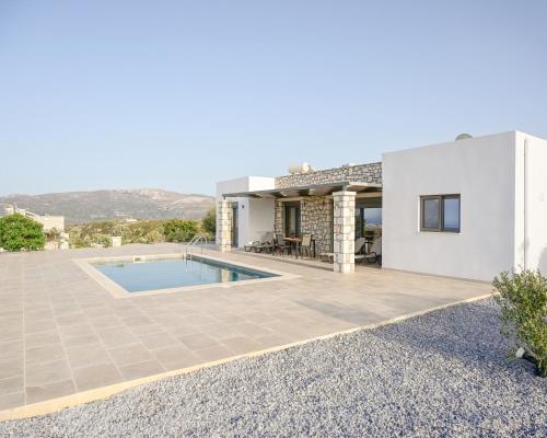 a villa with a swimming pool and a house at Villa Elaia in Sitia