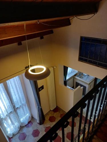 an overhead view of a staircase with a light at La Fortezza di Gavi - in Gavi