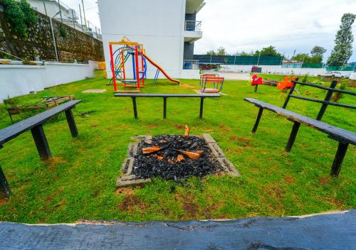a park with two benches and a playground at Kodai Outdoor Valley in Kodaikānāl
