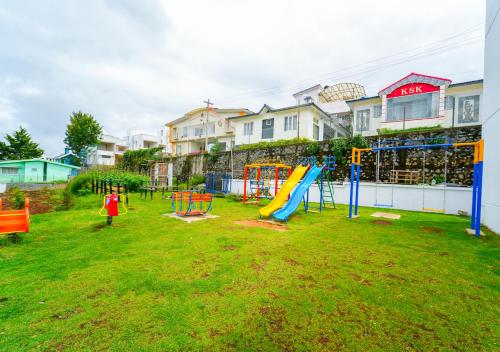 a playground with a slide in a yard at Kodai Outdoor Valley in Kodaikānāl