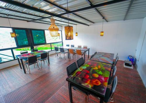 a dining room with a table with fruit on it at Kodai Outdoor Valley in Kodaikānāl