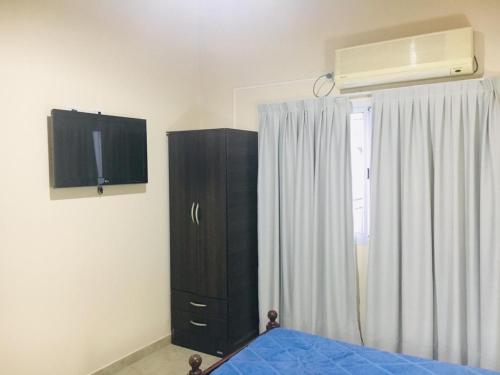 a bedroom with a bed and a dresser and a window at Mi Espacio in Colón