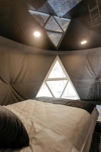a bedroom with a large bed with a window at Moncastro Glamping in Vylkove