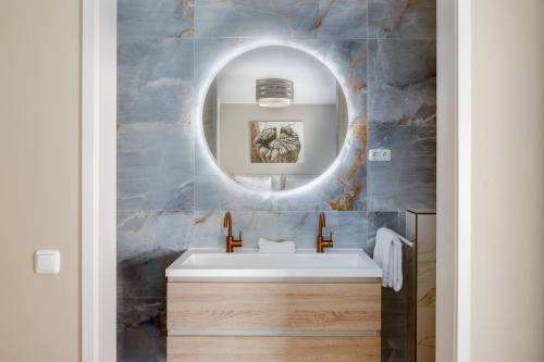 a bathroom with a sink and a mirror at Hof van Maldegem in Kortgene