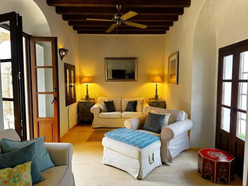 un soggiorno con due divani e un ventilatore a soffitto di Casa de Medina a Medina Sidonia