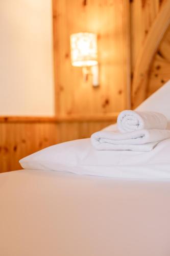 a bed with white towels on top of it at Hotel Berghof in Neustift im Stubaital
