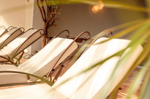 a row of white chairs sitting in a room at Hotel Berghof in Neustift im Stubaital