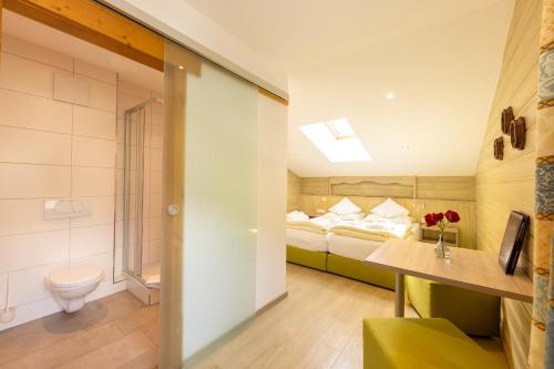 a bedroom with a bed and a toilet in a room at Hotel Berghof in Neustift im Stubaital