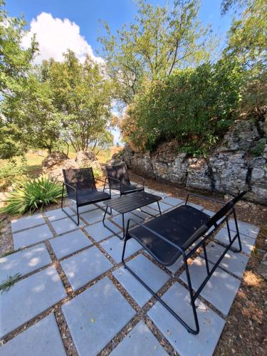 two chairs and a table on a stone patio at Apartment Vidak in Labin