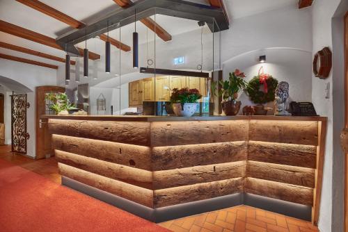 a kitchen with a counter with wooden logs at Aktivhotel & Gasthof Schmelz Ihr familienfreundliches Urlaubs Hotel mit Wellness Hallenbad, Alpensauna neu ab Februar 2026 Chiemgau Karte in Inzell