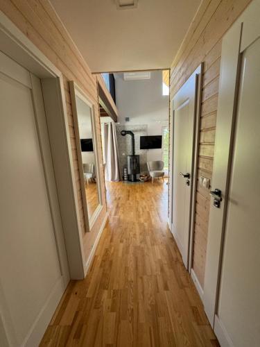 a hallway with wooden flooring in a house at Jaśminowy Sad in Mikołajki