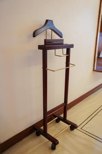 a wooden stand with two shelves on a floor at Clarion Bella Casa at Airport in Jaipur