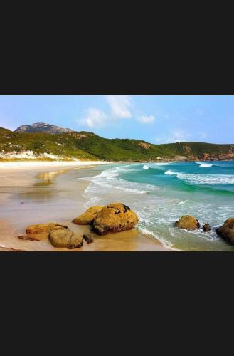 a view of a beach with rocks and the ocean at Sandy point hideaway in Sandy Point