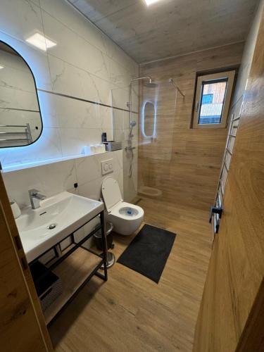 a bathroom with a white sink and a toilet at Apartmán I2 in Hrabušice
