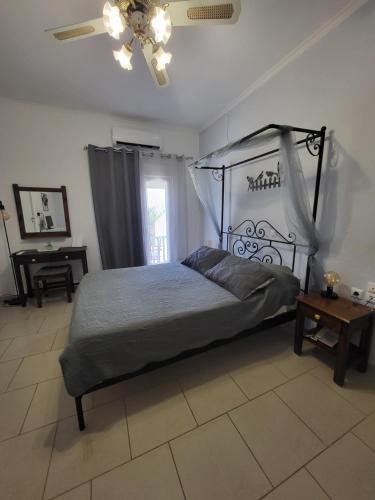a bedroom with a canopy bed and a table at Liogerma in Adamas