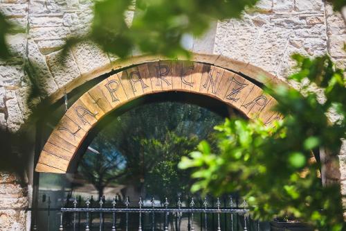 an archway over a fence in front of a building at Casa Romantica La Parenzana in Buje