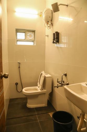 a bathroom with a toilet and a sink at F-3 Tulsi By The Peace in Chennai