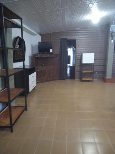 a large room with a room with a wooden floor at Pousada Chale Pico da Bandeira in Alto Caparao