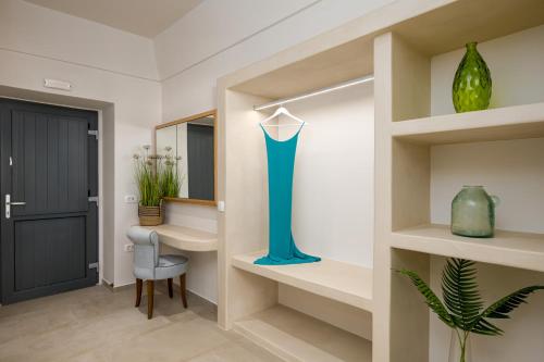 a hallway with a table and a blue vase at Galaria Serenity Suites in Vóthon