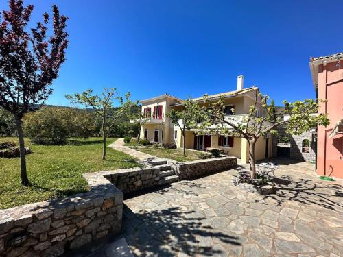 a house with a stone wall next to a building at Stone Villa Maria in Galaxidhion