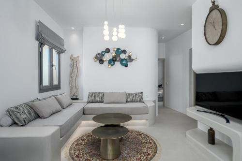 a living room with a couch and a table at Galaria Serenity Suites in Vóthon