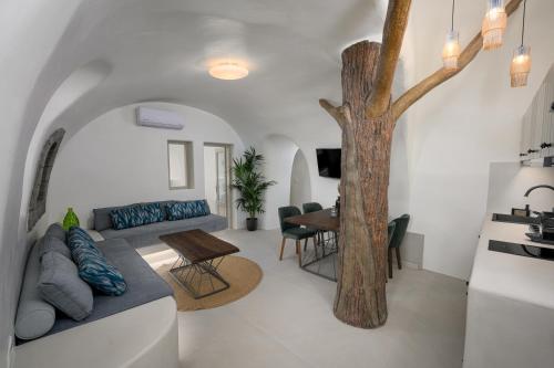 a living room with a couch and a tree at Galaria Serenity Suites in Vóthon
