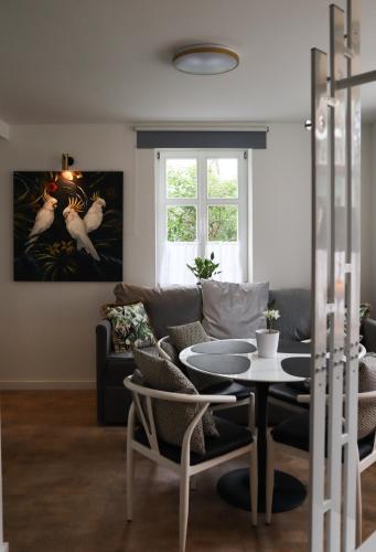 a living room with a couch and a table at Apartamenty Pocztowe in Opolno Zdrój