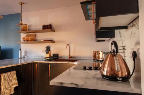 a kitchen with a tea kettle on a counter at The Bradan - Troon - Coorie Doon Stays in Troon