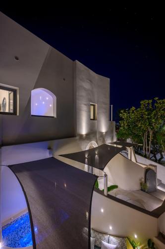 a house with a swimming pool at night at Galaria Serenity Suites in Vóthon