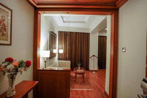 a hallway with a living room with a mirror at Clarion Bella Casa at Airport in Jaipur
