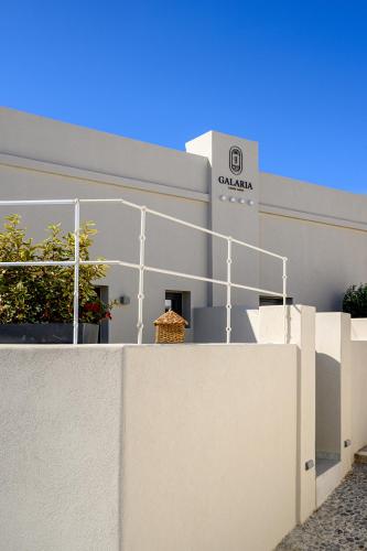 a white building with a sign on the side of it at Galaria Serenity Suites in Vóthon