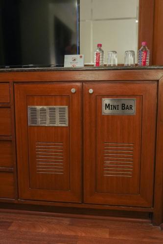 a wooden cabinet with a think bar sign on it at Clarion Bella Casa at Airport in Jaipur