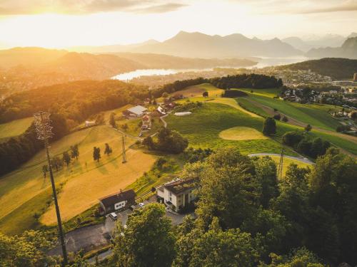 a house on a hill with a golf course at Hotel Sonnenberg in Luzern