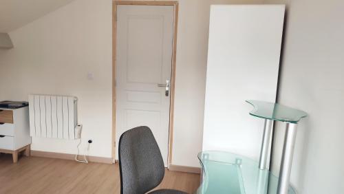 a room with a glass table and a chair at Studio Pour Une deux Personnes in La Courneuve