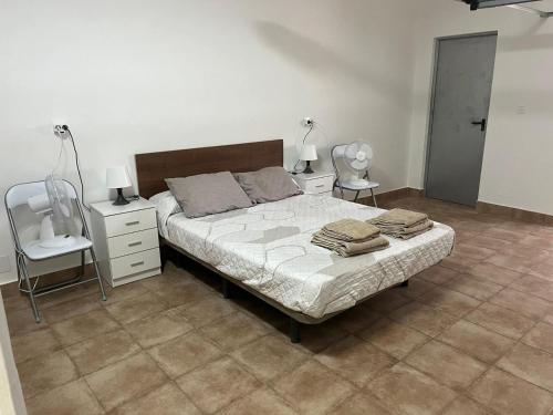 a bedroom with a bed with two night stands and two lamps at Casa MARISA in Águilas