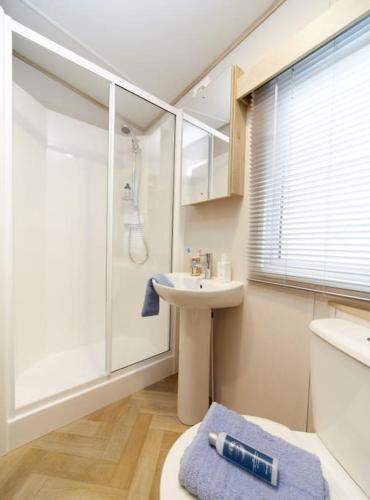 a bathroom with a sink and a shower at Elegant 2 Bed 1 and Half Bath Caravan in Holiday Resort Village in Northampton