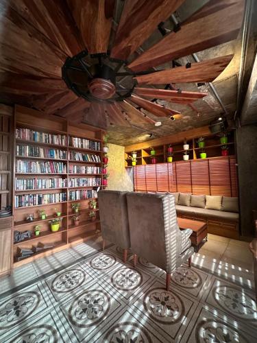 a living room with a couch and bookshelves at Clarion Bella Casa at Airport in Jaipur